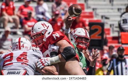 Lincoln, Nebraska, USA - May 1, 2021: Quarterback Logan Smothers throws the ball over the defense in the annual Red-White Spring Game at the University of Nebraska-Lincoln.