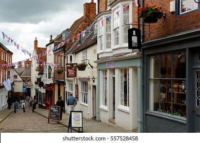 LINCOLN, UK - JULY 1, 2016: Shops lining Strait street leading to High street in the historic quarter of Lincoln City Centre, Lincolnshire.