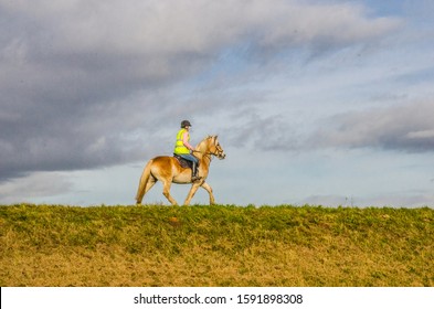 Lincolnshire, England UK. November 9 2017. Lone Horse Rider With Cloudy Sky. With No Other Features.