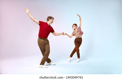 Lindy hop couple in motion in retro vintage style is dancing to the jazz 