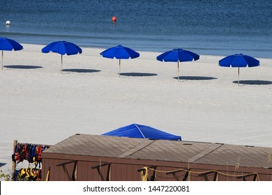 A Line Of Blue Beach Umbrellas On The Beautiful Beach To Just Kick Back And Relax.