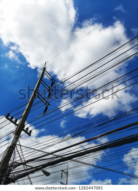 The\
electricity​ line with blue sky and the cloud\
