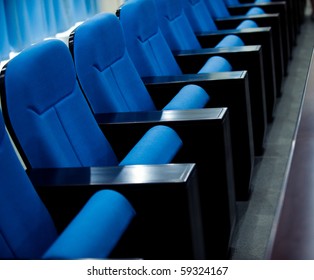 a line of blue theater chairs.