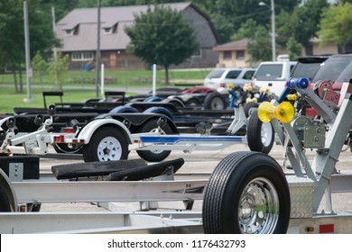 Line of Boat Trailers in a Parking Lot by a Lake Boat Launch