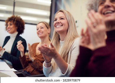 Line Of Businesswomen In Modern Office Applauding Presentation By Colleague