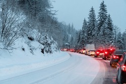 A Line Of Cars On A Snow-covered Road. Long Wait In Line After A Car Accident.