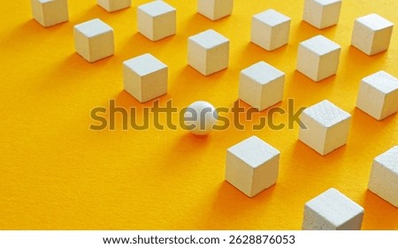 A line of cubes and sphere. Thinking differently and breaking patterns.