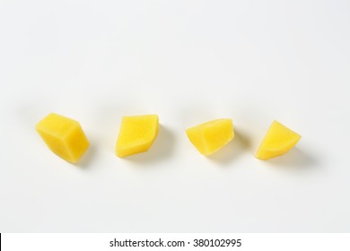 line of diced potatoes on white background