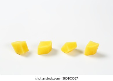 line of diced potatoes on white background