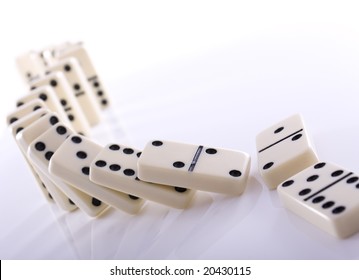 Line Of Dominos Falling Down After Being Pushed Over