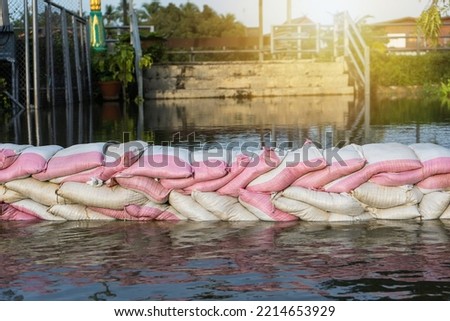 line flood barrier sandbag from the Tha Chin River that overflows in the flood season at Nakhon Chai Si District Nakhon Pathom Province of Thailand.