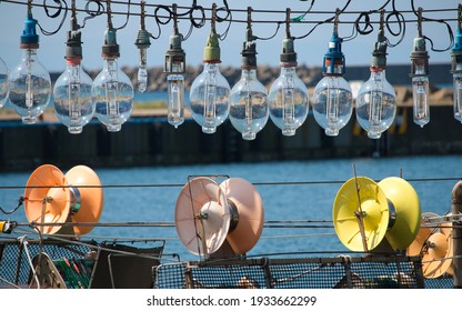 A Line Of Lightbulbs On A Squid Boat Suspended Over Colourful Jigging Machinery