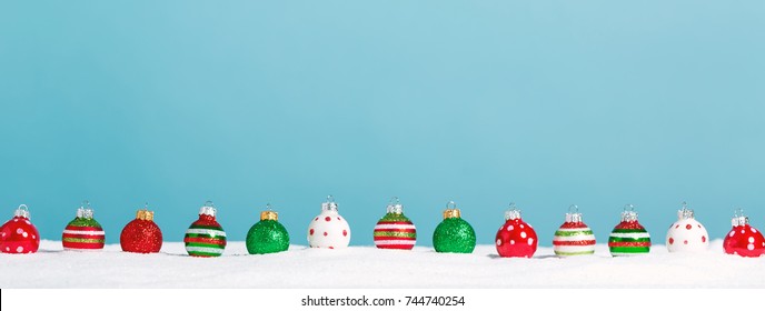 Line Of Little Bauble Ornaments On A Snow Mound