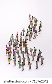 Line Of Miniature People View From Above, Over White Background.