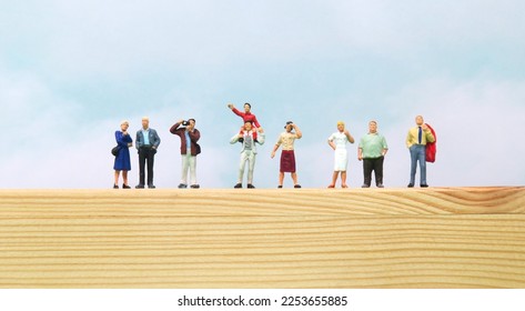 Line of Miniature People Watching Parade from Top of Wooden Box. - Shutterstock ID 2253655885