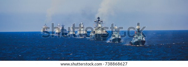A line of modern russian military naval battleships\
warships in the row, northern fleet and baltic sea fleet in the\
open sea\
