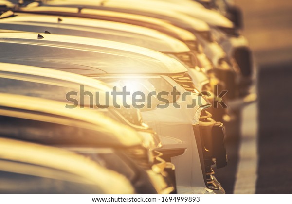 Line of Modern Vehicles Closeup.\
Automotive Business Theme. Car Dealership Parking Lot.\
