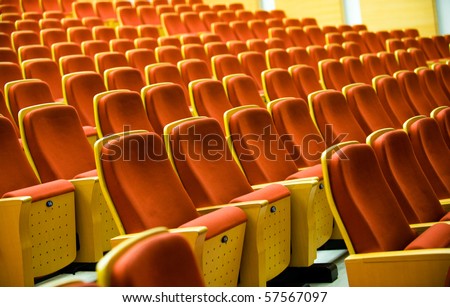 A line of red theater chairs.