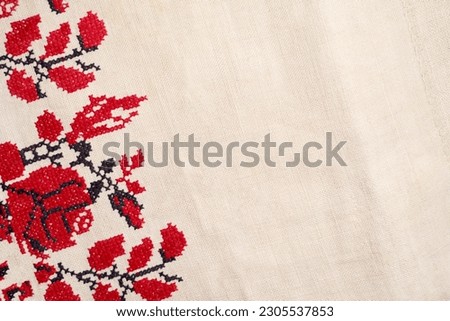 Line striped closeup weave fabric for kitchen towel material. Pinstripe fiber picnic table cloth . Black and red embroidery. Embroidered good like old handmade cross-stitch ethnic Ukraine pattern. 