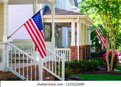 A line of suburban homes display large American Flags - Powered by Shutterstock