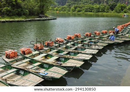 Line of tourism boats waiting for tourist at boat station in Tam Coc, Ninh Binh, Vietnam
