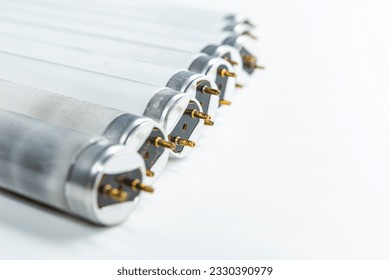 Line of Used Obsolete Fluorescence Lamps Placed on Pure White Background.Horizonta; Orientation