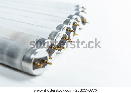 Line of Used Obsolete Fluorescence Lamps Placed on Pure White Background.Horizonta; Orientation