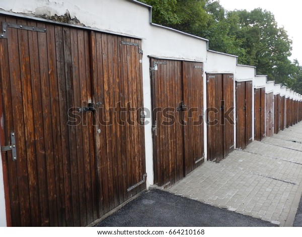 a line of\
wooden garage doors in shared\
garage