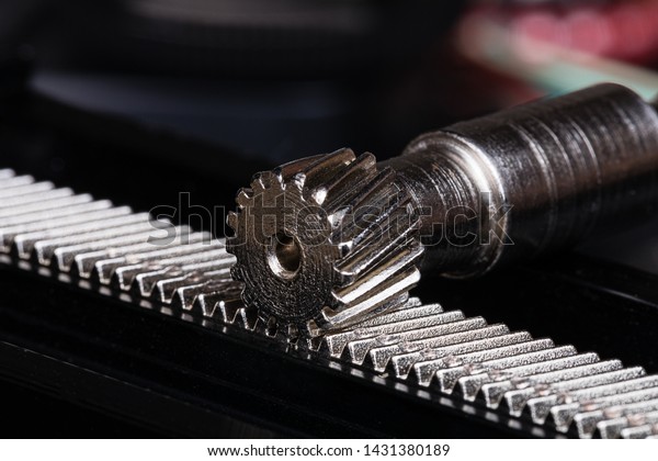Linear Rack gear with a pinion gear.  Mechanism\
for linear precision mechanical motion.  Often part of a step motor\
positioning system or a macro positioning system utilizing step\
motors.