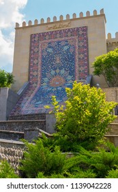 lined with a bright colored mosaic pattern in the form of a carpet on a concrete wall
