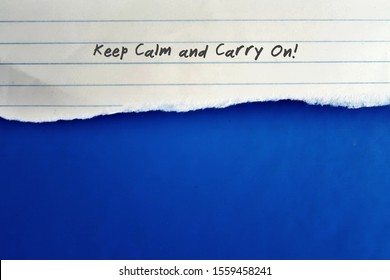 Lined note paper with text written KEEP CALM and CARRY ON , on blue copy space background , concept of self reminding to be persistent when facing challenge