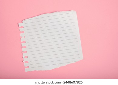 Lined notebook sheet with torn edges on pink background.
