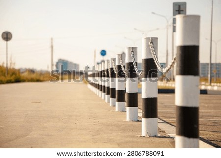 Lined up posts with chains, fences, protection from parking cars and protection of the pedestrian part of the road