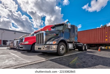 Lined Up Semi Trucks On A Parking Lot At Logistics Warehouse.