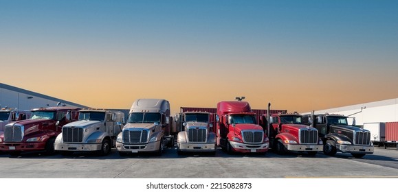 Lined Up Semi Trucks On A Parking Lot At Logistics Warehouse.