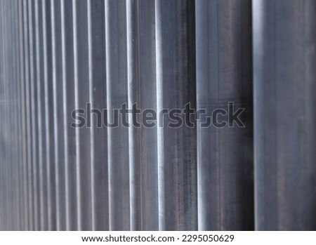 Lined up steel tubes reflecting sunlight