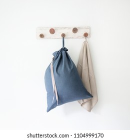 Linen Drawstring Bag Full Of Laundry On White Background.