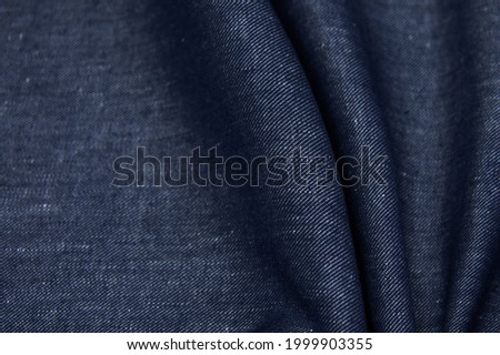 Linen fabric denim blue background. Wrinkled soft Linen blue fabric texture. Stone washed blue pure linen tablecloth background