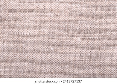 Linen fabric, surface, from above. Textile made from the fibers of the flax plant. Linen is very strong and absorbent and dries faster than cotton, therefore its comfortable to wear in hot weather.