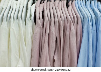 Linen multi-colored shirts hang on a hanger in the department store. - Powered by Shutterstock