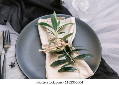 Linen Napkin With Olive Branch On Plate. Rustic Wedding Table Setting 