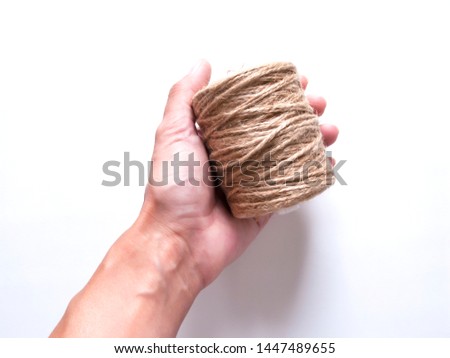 a linen reel of thread in a hand