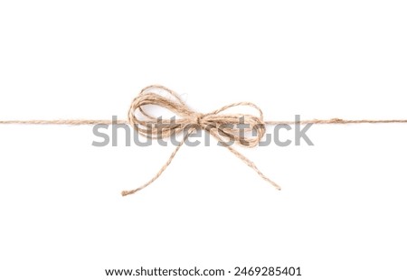 Linen rope string with bow isolated on white, top view