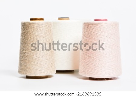 Linen and silk yarn bobbins isolated on white background