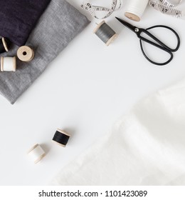 Linen Textiles, Scissors And Sewing Supplies On White Desk