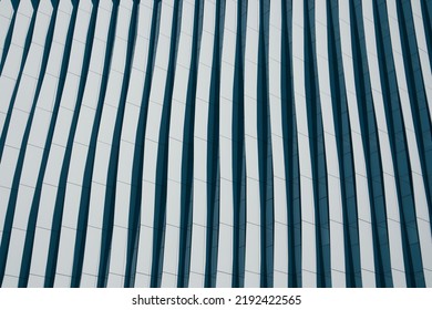 Lines In Architecture. Modern Office Facade. Fragment Of Tall Blue Building With Contrast Shadows. Abstract Built Structure Background. Business Quarter In A Modern City. Urban Scene Pattern, Texture.