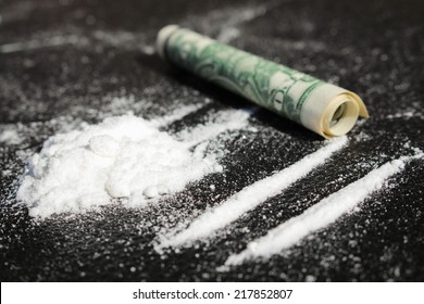 	Lines of cocaine and one dollar bill