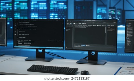 Lines of code running on computer screens in data center, used for troubleshooting rackmounts in server rows. Close up shot of script working on PC monitors upgrading hardware - Powered by Shutterstock