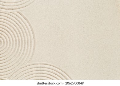Lines drawing on sand, beautiful sandy texture. Spa background, concept for meditation and relaxation. Concentration and spirituality in Japanese zen garden. View from above. - Shutterstock ID 2062700849