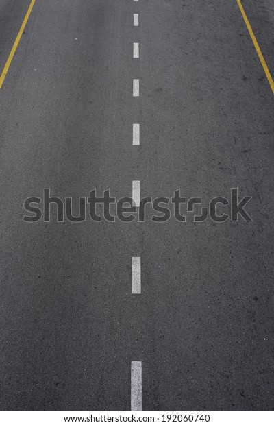 Lines and lane markings on the on asphalt road\
surface texture